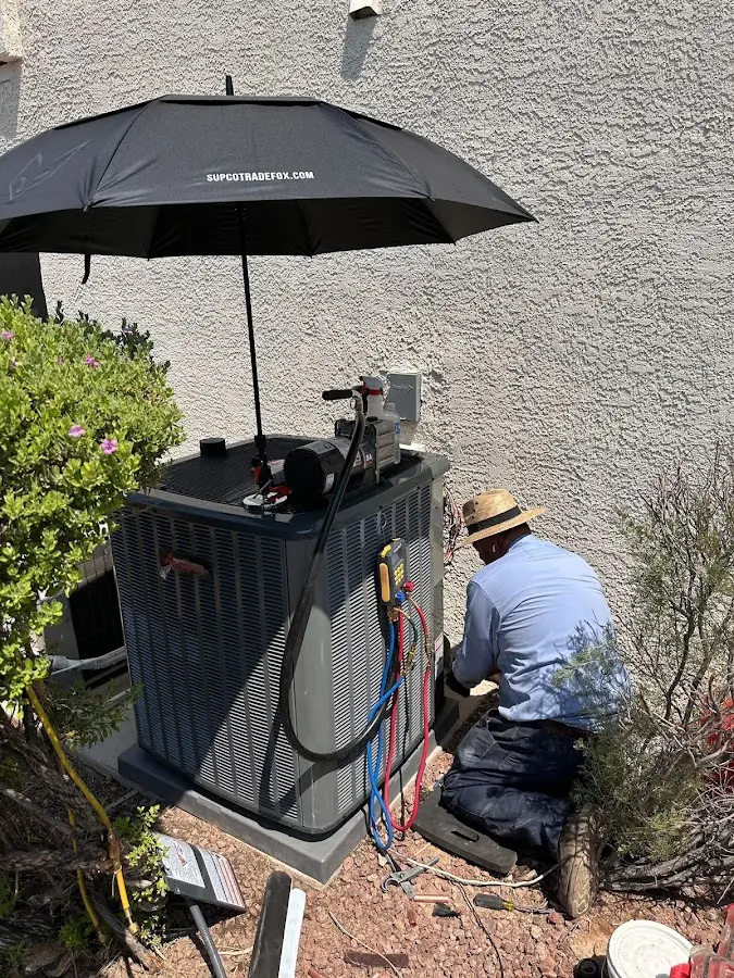 HVAC technician performing outdoor AC maintenance in New Albany